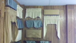 Display of various styles of rod pocket valances, and others.